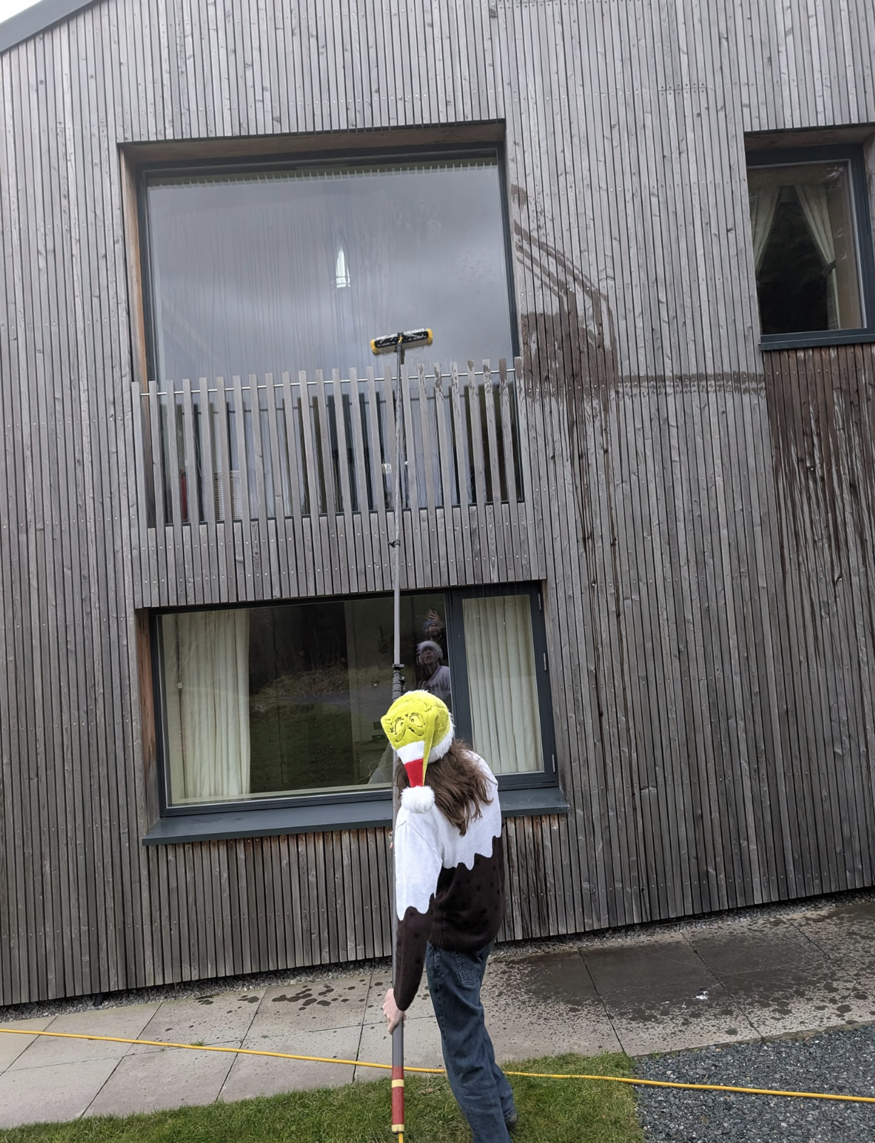Commercial building window cleaning using professional water-fed pole system